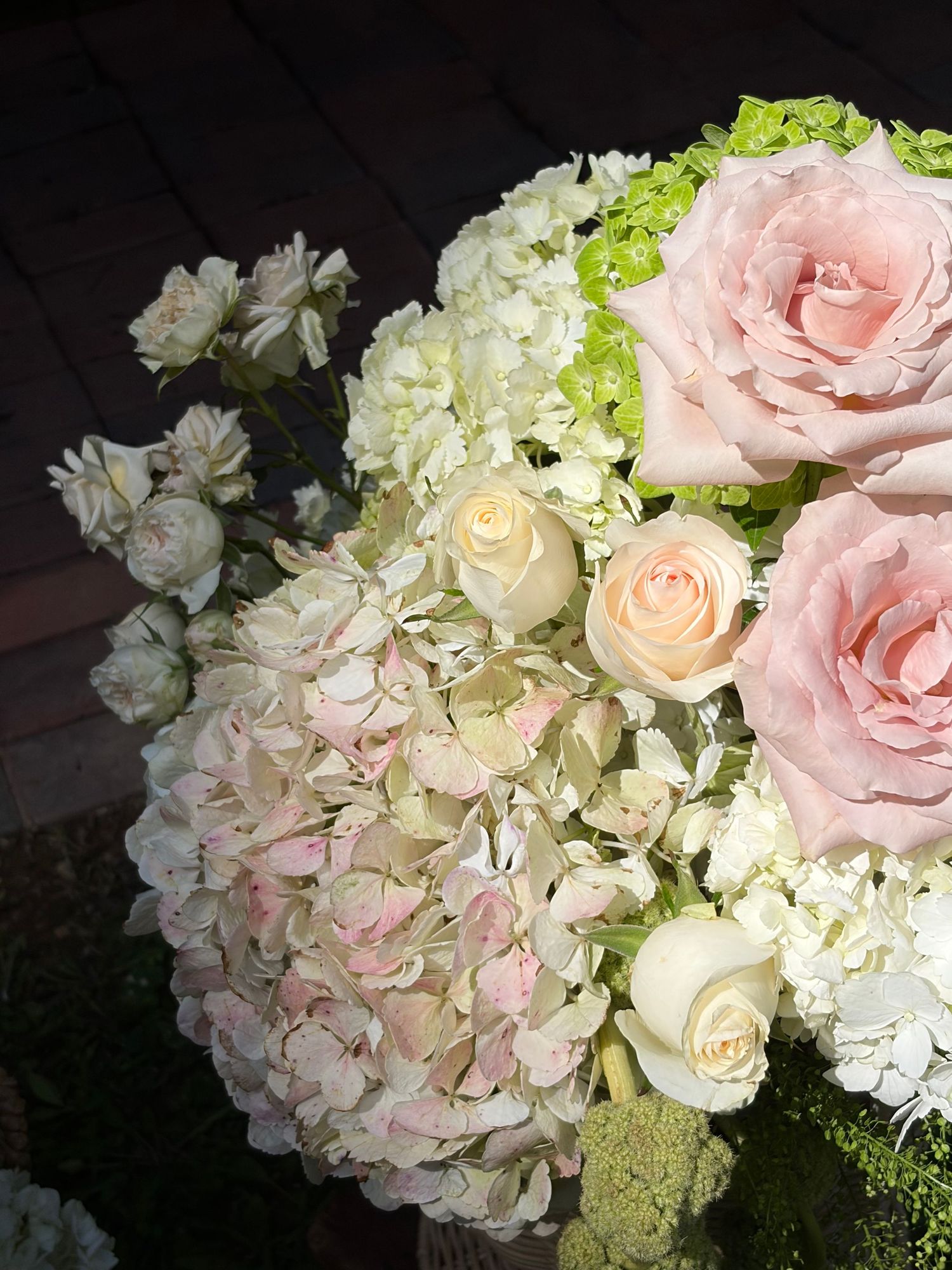 Pastel roses, white flowers and soft greenery arranged by Eden