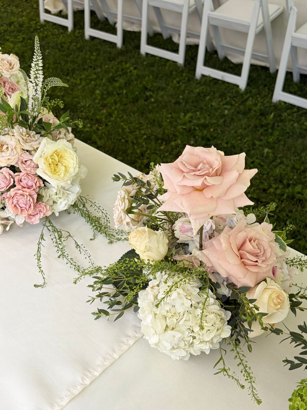 Soft pink and white floral centerpiece at a celebration