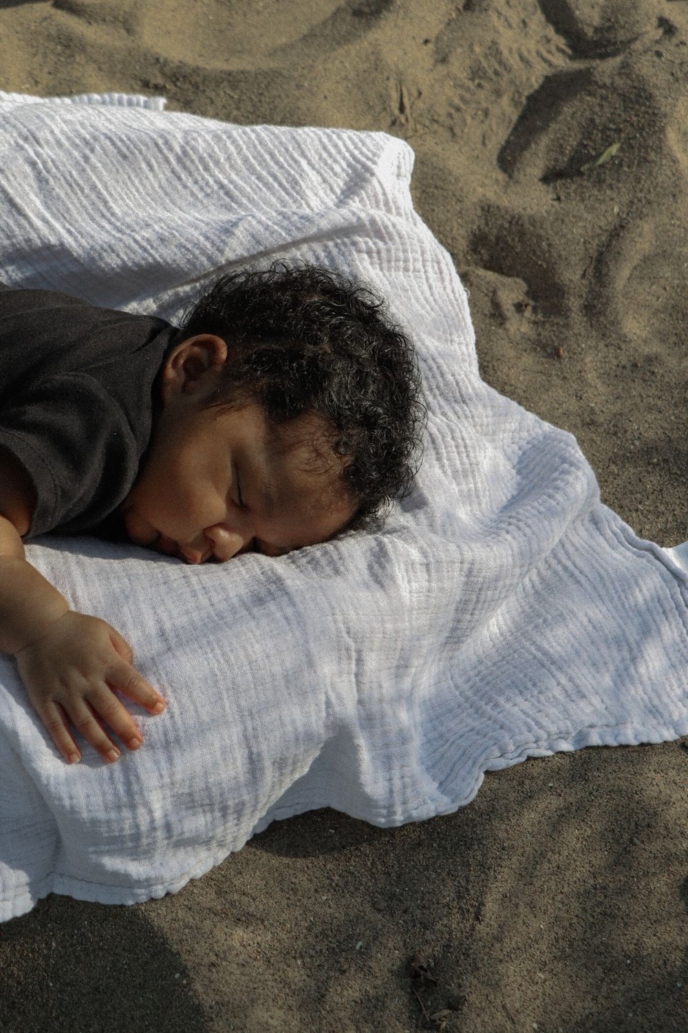 A quiet portrait resting on a picnic blanket at the beach