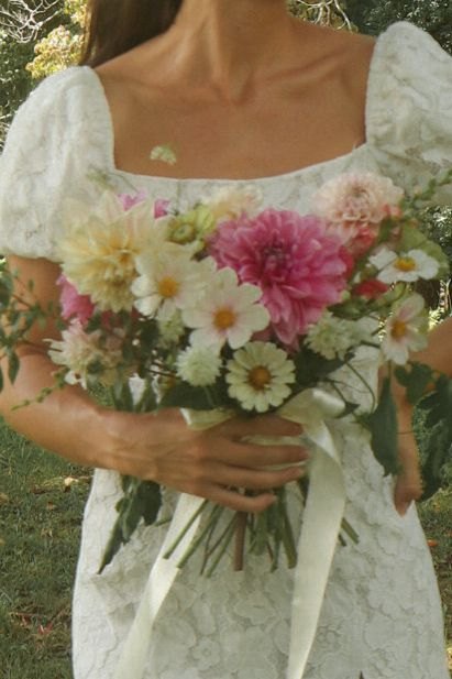 Bride carrying a bright seasonal bouquet